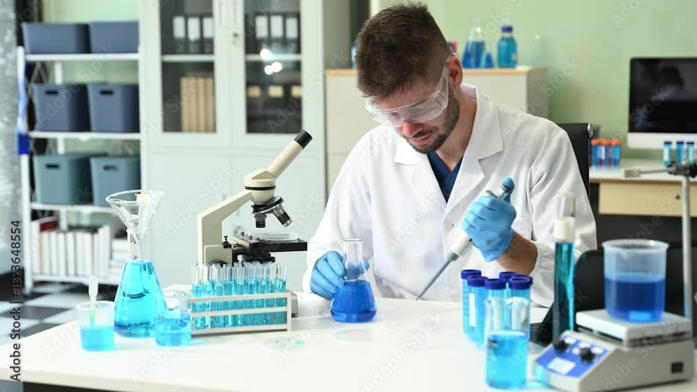 male scientist working with micro pipettes analyzing biochemical samples, advanced science chemical laboratory for medicine. male scientist working with micro pipettes analyzing biochemical samples, advanced science chemical laboratory for medicine.