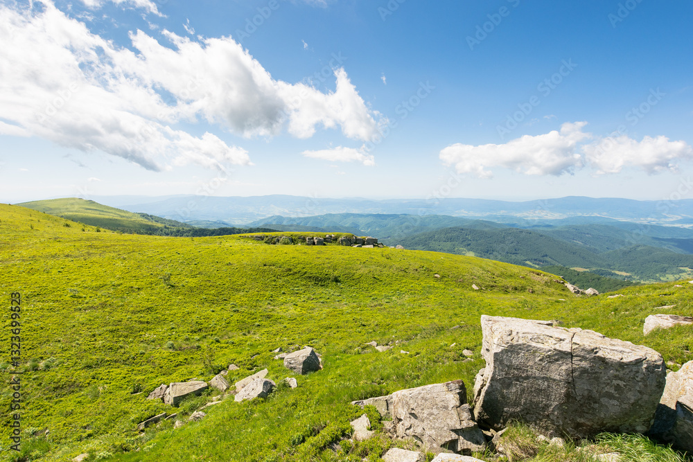 landscape with alpine meadow on a sunny morning. picturesque alps of ukraine. rocks on green hills of carpathian mountain nature. clouds on the blue sky