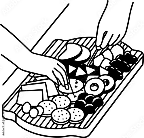 Appetizers and snacks platter with cheese, fruits, and crackers hand selecting from assorted food selection