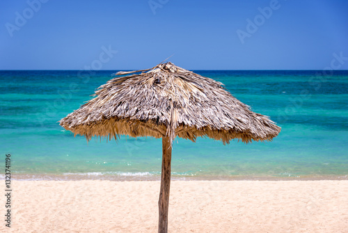 Obraz na płótnie Thatched parasol, sunshade on a beautiful tropical caribbean beach in Cuba w salonie