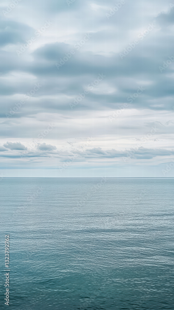 Serene Ocean under Cloudy Sky: The expanse of a calm ocean stretches towards the horizon under a sky adorned with soft, billowy clouds, offering a tranquil and contemplative scene. Serene Ocean under Cloudy Sky: The expanse of a calm ocean stretches towards the horizon under a sky adorned with soft, billowy clouds, offering a tranquil and contemplative scene.