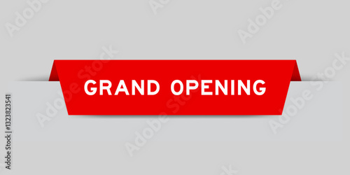 Red color inserted label with word grand opening on gray background