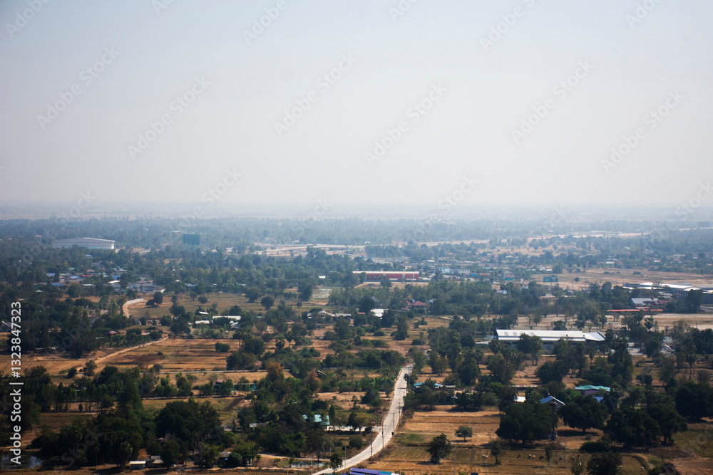 Obraz premium Aerial view landscape of rice field or paddy land and village countryside from viewpoint of Wat Khao Meng Amornmet Temple for thai people travelers travel visit at Pak Phraek in Kanchanaburi, Thailand