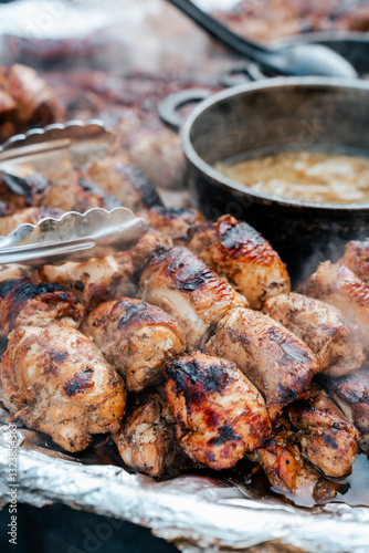Shashlik and soup on fair, farmers market stand. Close up of steamy street food.