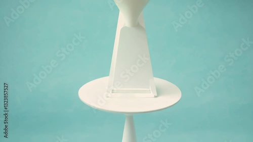 Stylish white side table on a turquoise background for modern decor inspiration.
