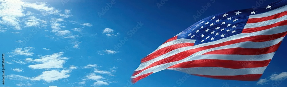 American Flag Waving in Blue Sky with Clouds, Symbol of Patriotism and Freedom American Flag Waving in Blue Sky with Clouds, Symbol of Patriotism and Freedom