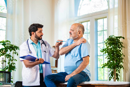 Indian Senior retired male patient undergoing physiotherapy assessment for shoulder, neck pain