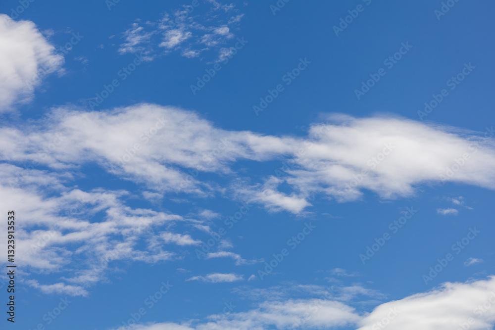 Blue sky with scattered white clouds Blue sky with scattered white clouds