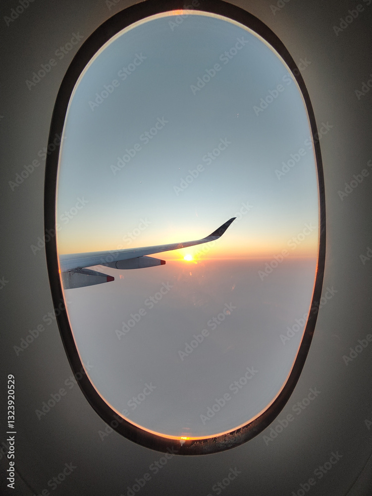 The breathtaking view of the sunrise from an airplane window