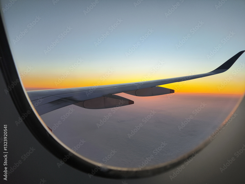 The breathtaking view of the sunrise from an airplane window
