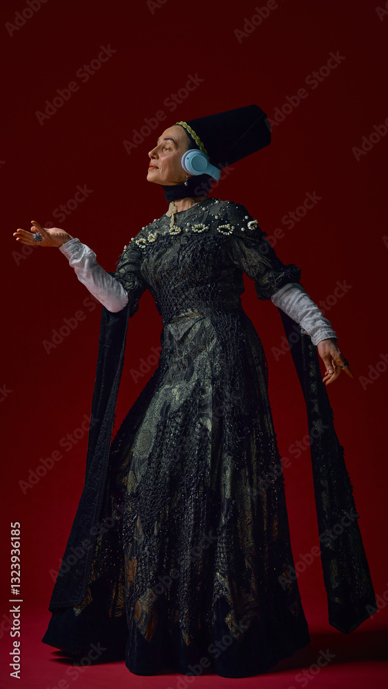 Elderly woman in renaissance attire gracefully raising hand while wearing modern headphones, immersed in music against deep red background. Concept of art, vintage, renaissance, noble times Elderly woman in renaissance attire gracefully raising hand while wearing modern headphones, immersed in music against deep red background. Concept of art, vintage, renaissance, noble times