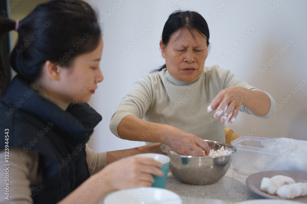 Asian mother and daughter cooking Banh Troi Nuoc in Cold Food festival Asian mother and daughter cooking Banh Troi Nuoc in Cold Food festival