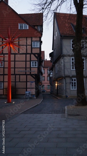 In the old centre of a German city, 16th- and 17th-century houses line narrow streets next to a mid-20th-century metal star