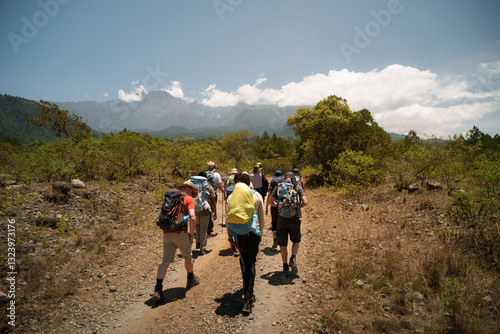 Tourists hiking towards mount meru on international africa day photo