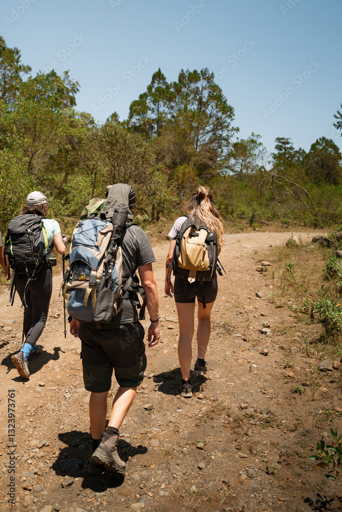 Hikers walking on a trail on mount meru, celebrating international africa day Hikers walking on a trail on mount meru, celebrating international africa day