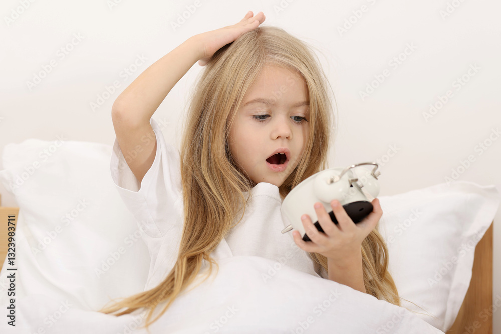 Overslept girl with alarm clock in bed at home Overslept girl with alarm clock in bed at home