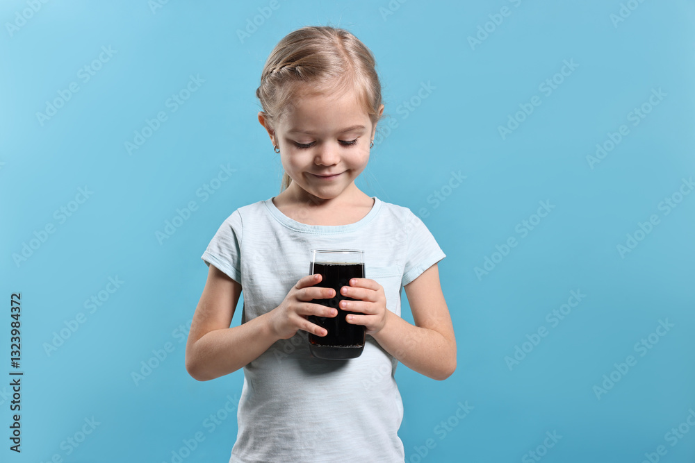 Girl with glass of refreshing soda drink on light blue background Girl with glass of refreshing soda drink on light blue background