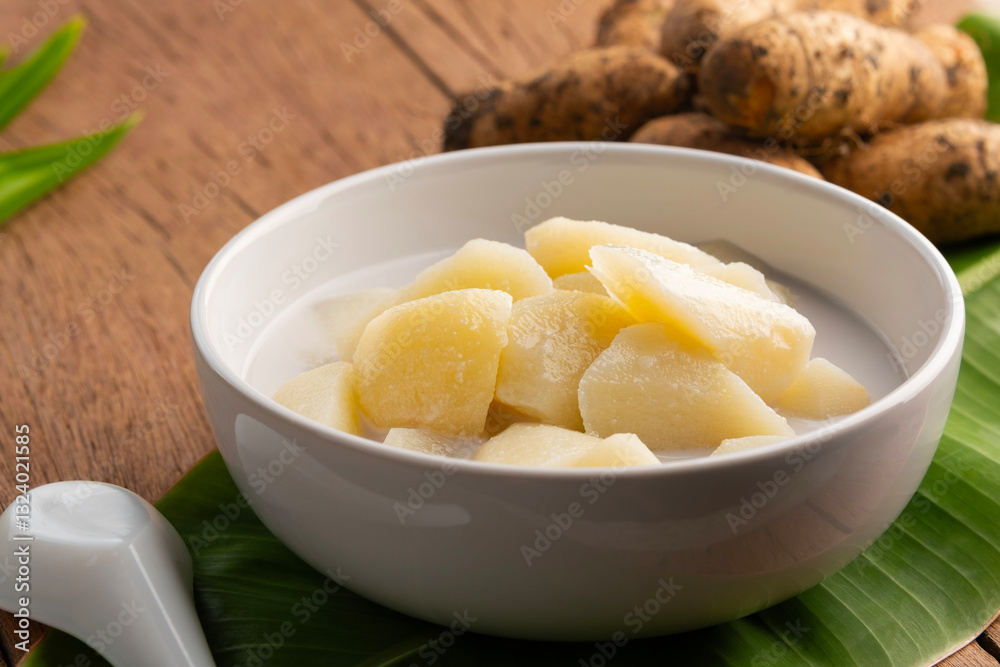 Coconut Milk Stewed yam (D. esculenta(Lour.) Burkill),Thai dessert boiled sliced Dioscorea esculenta yam in coconut milk with sugar in white bowl. Coconut Milk Stewed yam (D. esculenta(Lour.) Burkill),Thai dessert boiled sliced Dioscorea esculenta yam in coconut milk with sugar in white bowl.