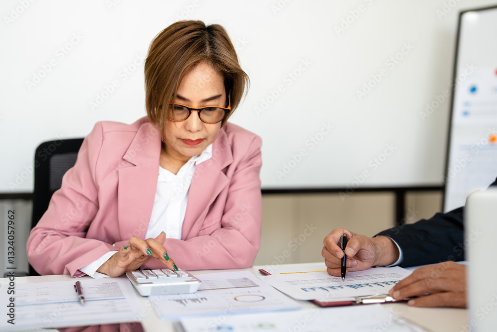 Auditor and accountant team working in office, analyze financial data and accounting record with calculator. Accounting company provide finance and taxation planning for profitable cash flow. Insight Auditor and accountant team working in office, analyze financial data and accounting record with calculator. Accounting company provide finance and taxation planning for profitable cash flow. Insight