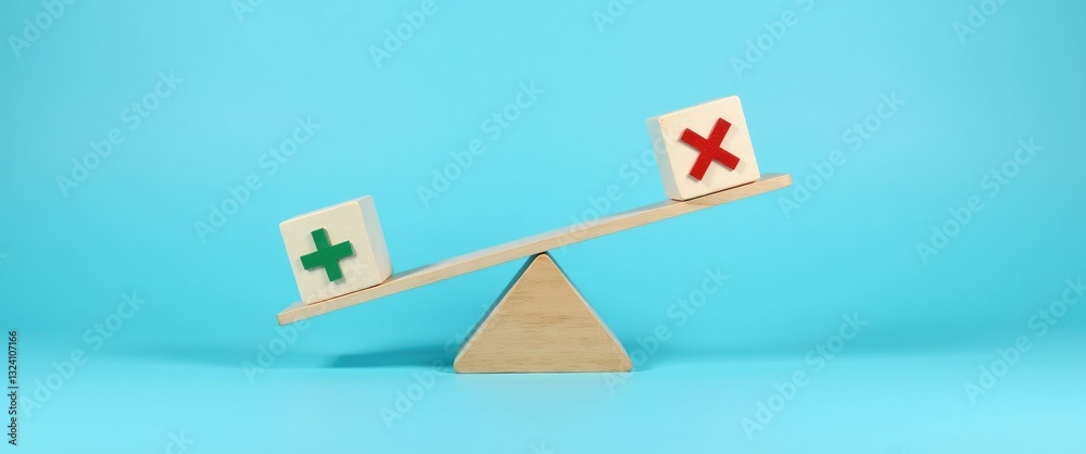 Plus and minus or positive and negative symbols on wooden blocks are balanced on a wooden seesaw against a blue background in a flat lay view.