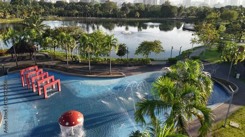 kuala lumpur park sunrise sun with blue lake and pedestrian jog