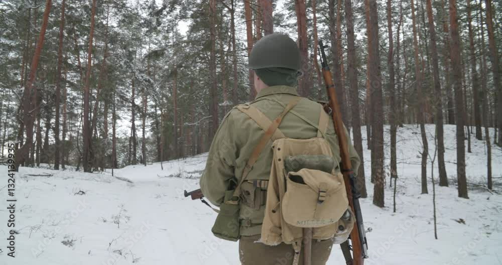 Re-enactor Dressed As American Infantry Soldier Going Through Forest Road In Cold Winter Day. Usa Soldier Marching By Country Road. Usa Army Soldiers Of World War Ii. Heroes Of War Re-enactor Dressed As American Infantry Soldier Going Through Forest Road In Cold Winter Day. Usa Soldier Marching By Country Road. Usa Army Soldiers Of World War Ii. Heroes Of War