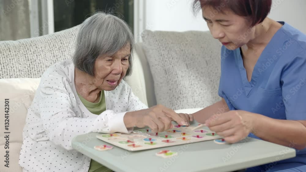 Nurse in nursing home helping elderly woman play number puzzle game. Dementia, Alzheimer's disease. Nurse in nursing home helping elderly woman play number puzzle game. Dementia, Alzheimer's disease.