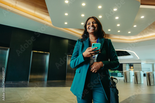 Confident professional woman walking in modern corporate lobby
