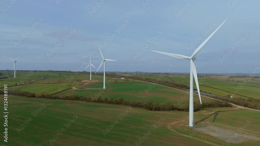 Aerial view of wind turbine farm in English countryside UK Europe Green renewable energy green revolution Clean energy drive sunny day Aerial view of wind turbine farm in English countryside UK Europe Green renewable energy green revolution Clean energy drive sunny day