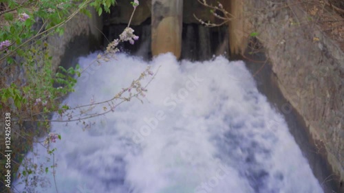blur shot of water flowing from dam, India