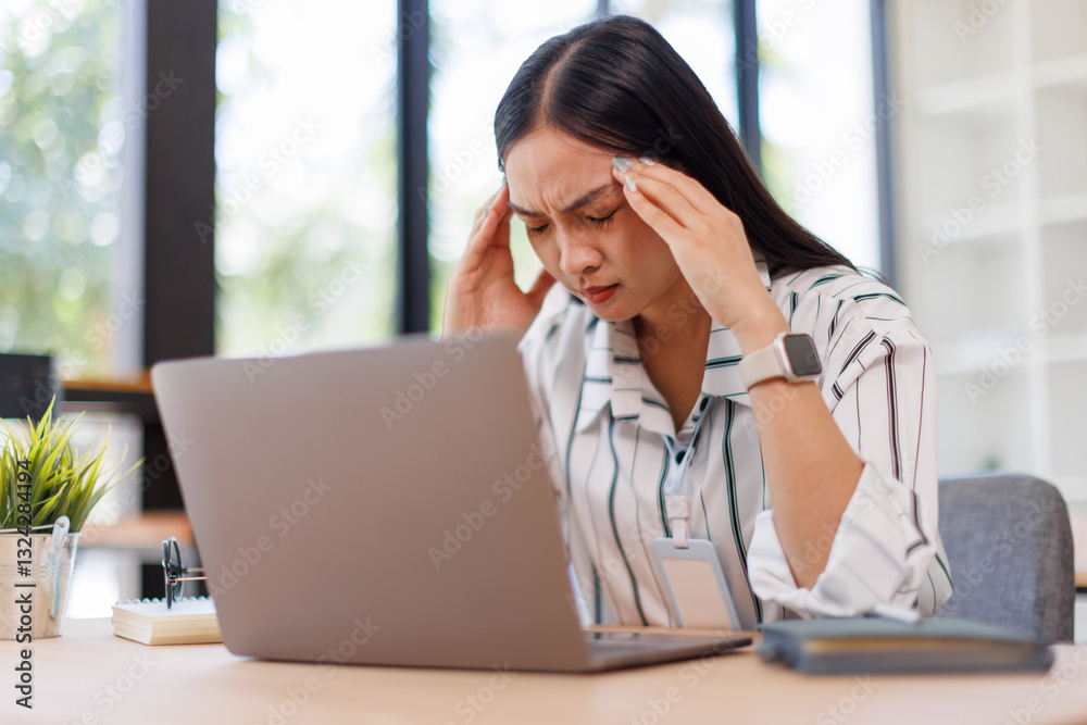 Young business asian woman feeling tired and having a headache while working on a laptop computer and napping at desk in the office.
Young business asian woman feeling tired and having a headache while working on a laptop computer and napping at desk in the office.