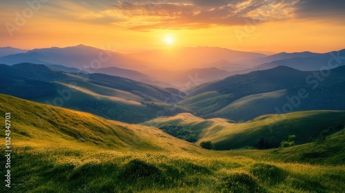 Of a Majestic mountain landscape with rolling green hills and a golden sunrise casting warm light over the valley