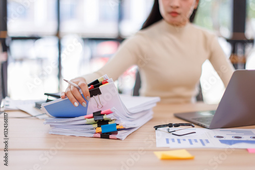 Business Business Documents, woman hands working in Stacks of paper files for searching and checking unfinished document achieves on folders papers
