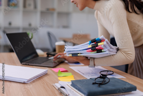 Business Business Documents, woman hands working in Stacks of paper files for searching and checking unfinished document achieves on folders papers
