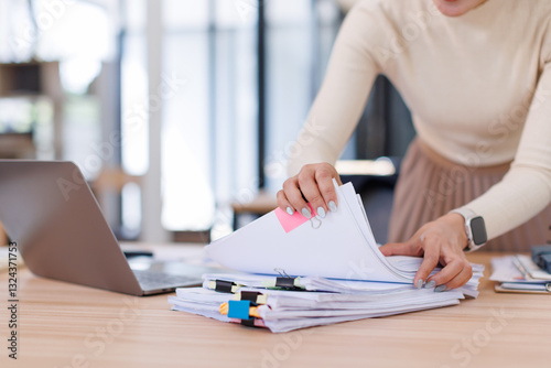 Business Business Documents, woman hands working in Stacks of paper files for searching and checking unfinished document achieves on folders papers
