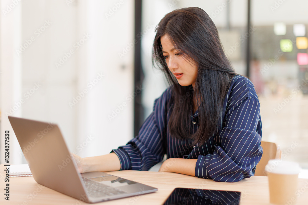 Portrait of tired young business Asian woman work with documents tax laptop computer in office. Sad, unhappy, Worried, Depression, or employee life stress concept Portrait of tired young business Asian woman work with documents tax laptop computer in office. Sad, unhappy, Worried, Depression, or employee life stress concept