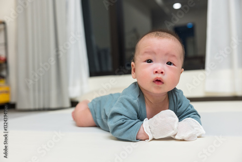 Wallpaper Mural Newborn baby wearing glove lying on carpet Torontodigital.ca