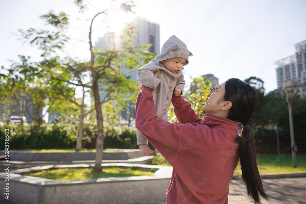 Mother playing with baby in the park