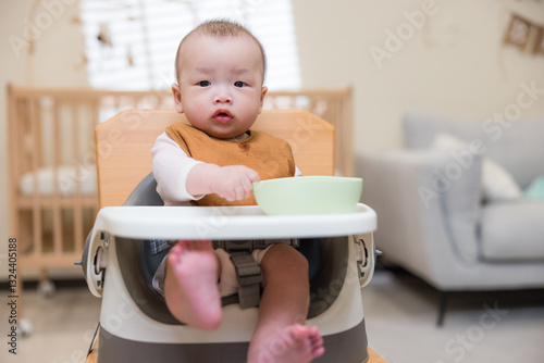Wallpaper Mural Cute baby holding bowl in dining chair Torontodigital.ca
