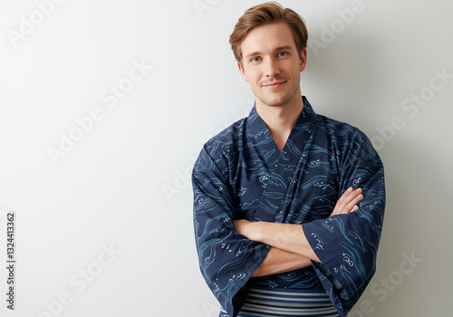 A white man wearing a yukata with his arms crossed- traditional attire