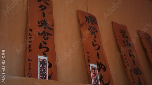 Beautiful wooden signage showcasing a variety of delicious ramen dishes in an authentic Japanese restaurant setting