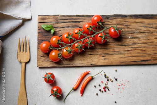 Healthy cherry tomatoes, on a wooden board. 
