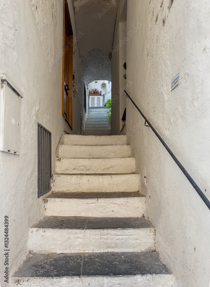 Obraz premium Amalfi, Salerno, Italy - July 6, 2024: Salita d'Ancora, narrow alley with big stairs up