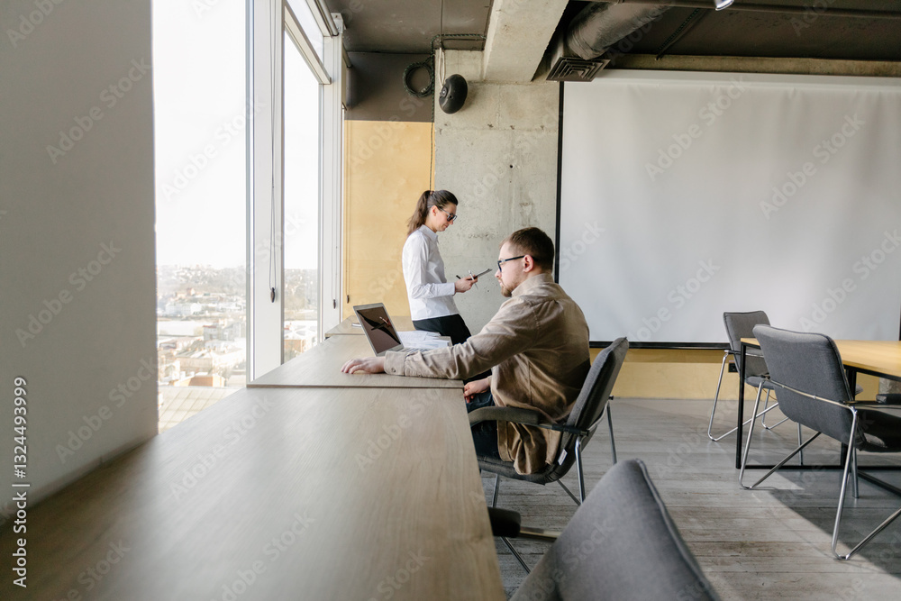 Two people working in the office Two people working in the office