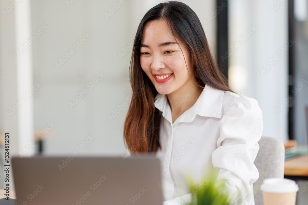 Young confident smiling asian woman using laptop at workplace office. online business work.
Young confident smiling asian woman using laptop at workplace office. online business work.