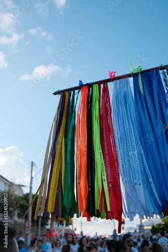 Wallpaper Mural Colorful fitinhas do Bonfim hang from a totem at a street vendor’s stand in Salvador, Bahia, captured from below during the Dia de Iemanjá celebration at Praia Vermelha. Torontodigital.ca