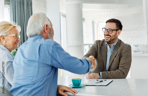 meeting agreement investment couple contract handshake advice retirement consultation senior elderly document deal insurance finance signing