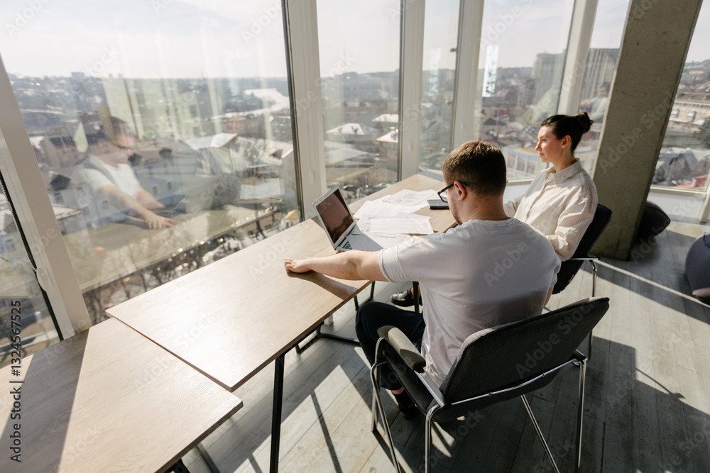 Two office workers working to together Two office workers working to together