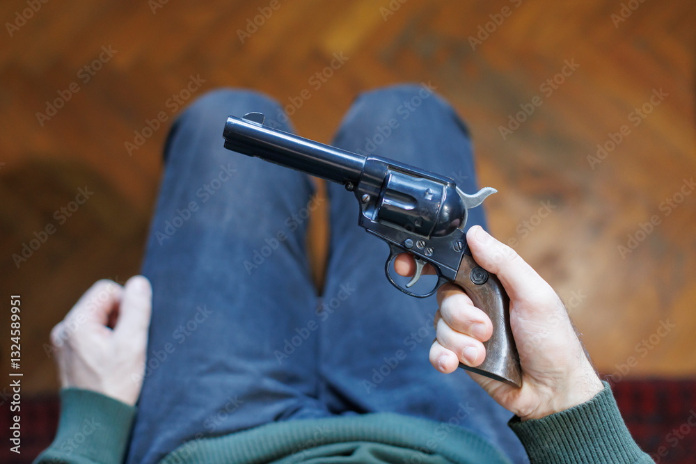 Obraz premium depressed man looking at a gun, contemplating suicide