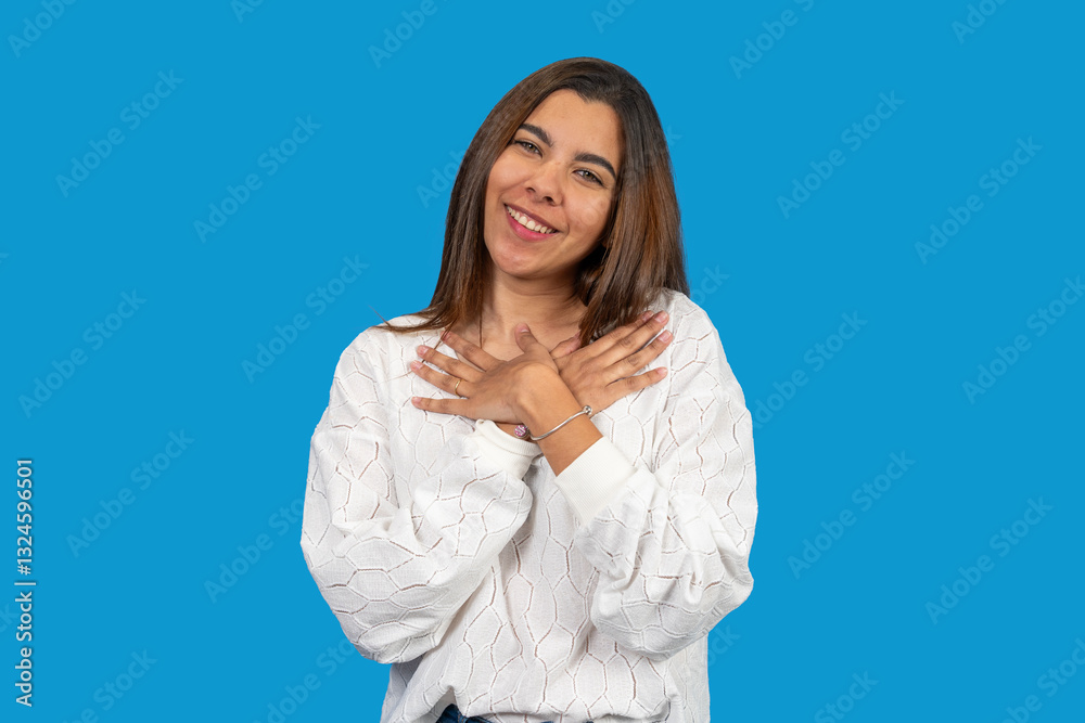 Young latin woman expressing gratitude and hope with hands on chest Young latin woman expressing gratitude and hope with hands on chest
